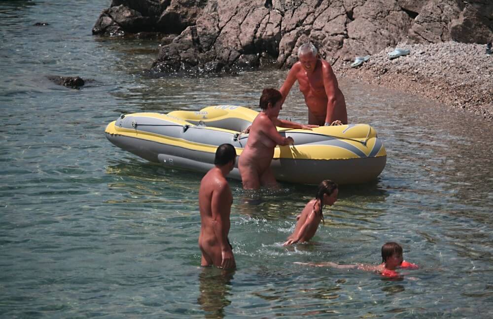 Lone Nudist in Yellow Boat photos - nudism in the world